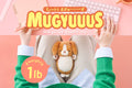 mugyuuus banner image featuring person in a green sweater typing at a desk against a pink background. text reads MUGYUUUS weighted cuddly toy weighs 1lb