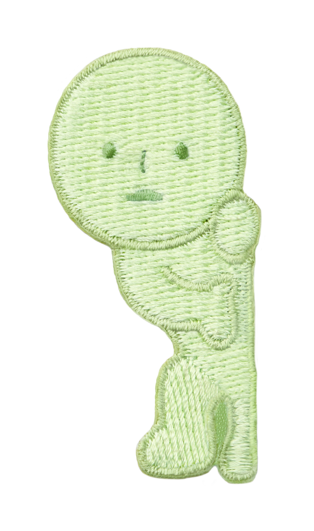 Image with transparent background shows SMISKI Embroidery Sticker "Peeking" SMISKI is a light green figure with dark green eyes, nose and mouth standing as if peeking around a doorway.